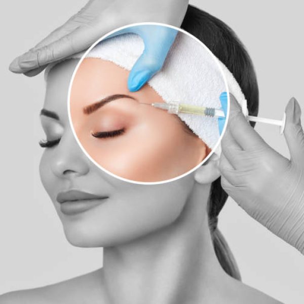 The doctor cosmetologist makes the Rejuvenating facial injections procedure for tightening and smoothing wrinkles on the face skin of a beautiful, young woman in a beauty salon.Cosmetology skin care.